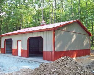 Tan two car pole building garage with red skirting and trim